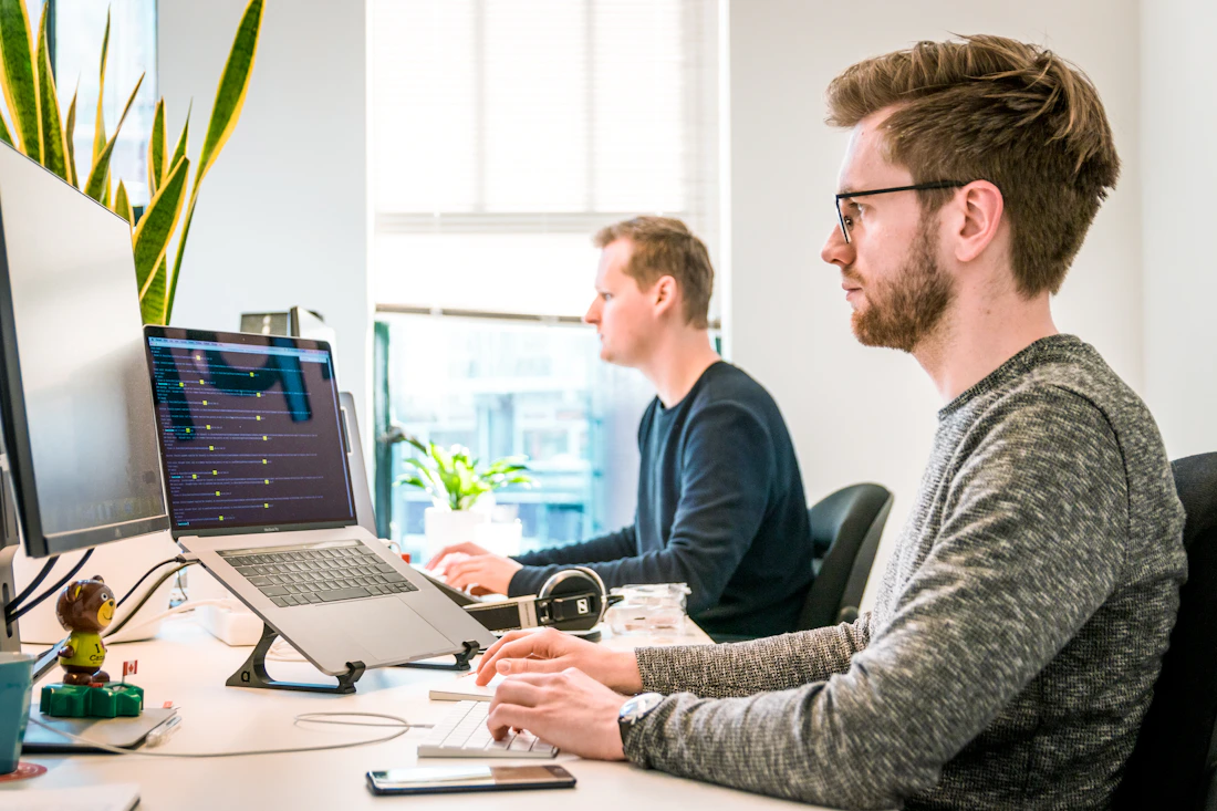 People collaborating on software in a bright shared workspace